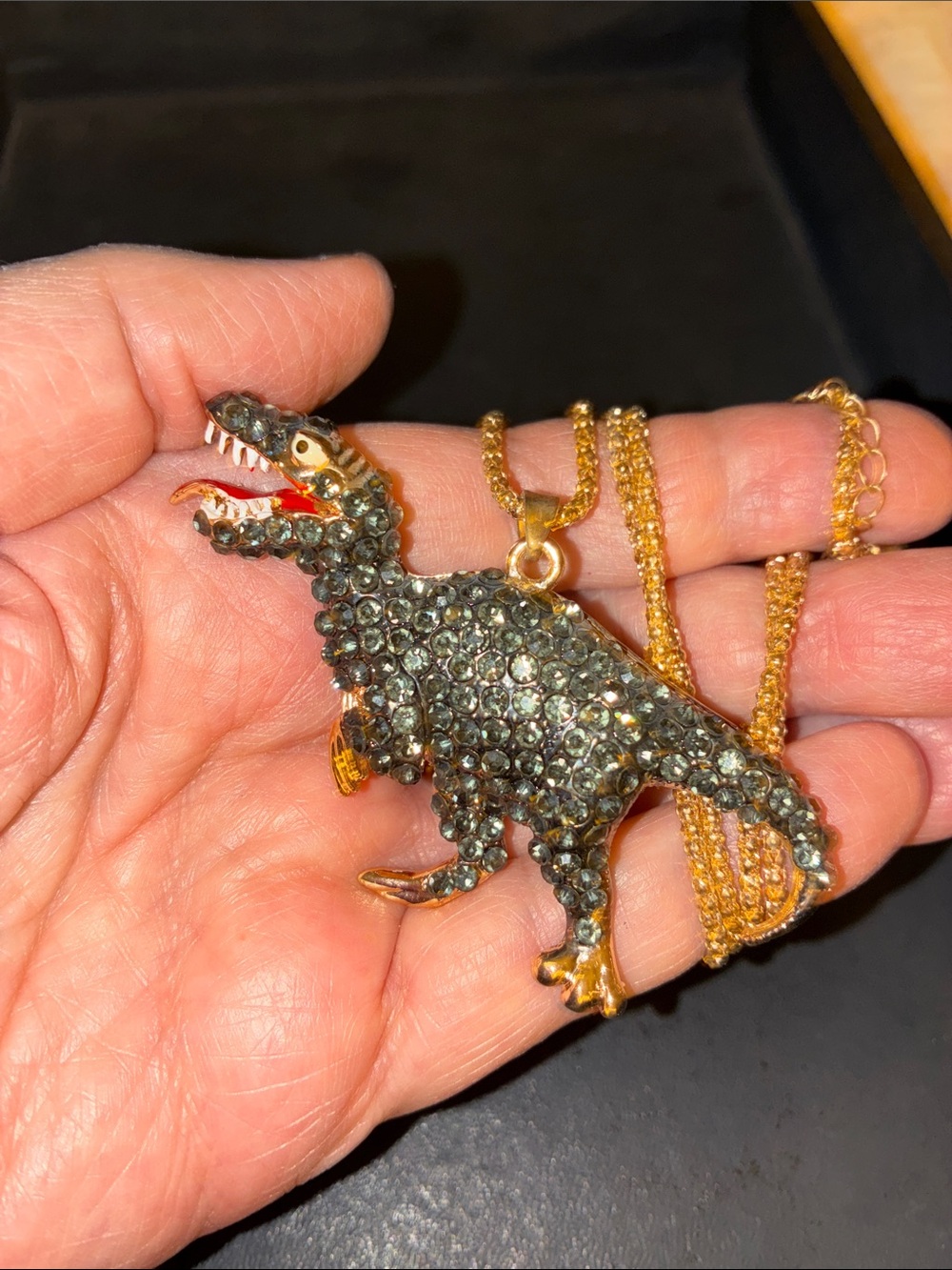 Black Crystal Dinosaur Pendant Necklace. Gold-Tone Accents